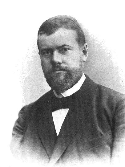 Max Weber (1864–1920) rozbił prostą oś Marksa na trzy odrębne wymiary pozycji społecznej: bogactwo, prestiż i władzę — które mogą się rozjeżdżać. · źródło: autor nieznany, Wikimedia Commons, domena publiczna